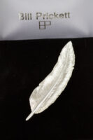 small and large feather brooch