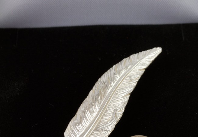 small feather brooch