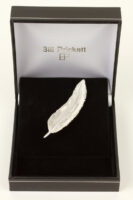 small feather brooch
