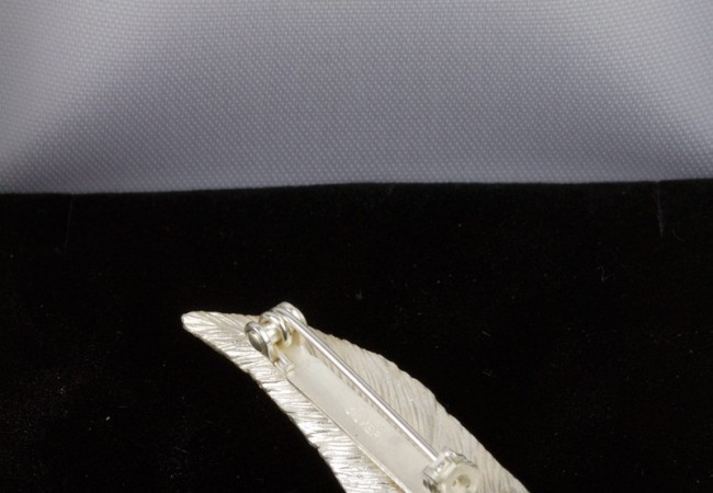 small feather brooch